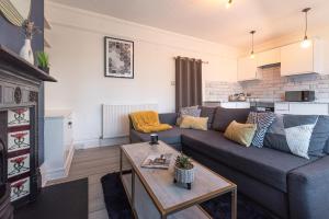 a living room with a couch and a table at Calverley Place -Long Stay Offer in Royal Tunbridge Wells