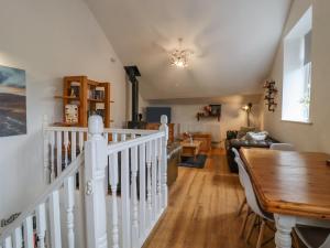 a living room with a staircase and a dining room at Ramblers Retreat in Settle