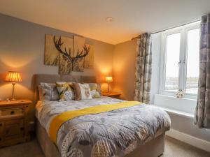 a bedroom with a bed and a window at Ramblers Retreat in Settle