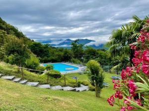 a resort with a swimming pool and mountains in the background at Residenza Viramonte, Casa Daniela, Appartement 37 in Vira