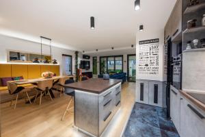 a kitchen and living room with a table and a dining room at Noble park in Zagreb