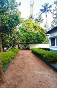 a dirt road in front of a house at Zebra Hostels in Varkala