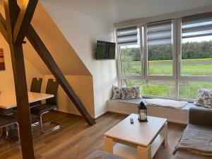 a living room with a couch and a table at Wunderschöne Ferienwohnung auf dem Bauernhof in Greven
