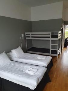 a bedroom with two beds and a bunk bed at Hotell Eskilstuna in Eskilstuna