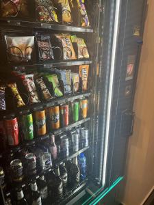 a refrigerator filled with lots of food and drinks at Hotel Garni Moers in Moers +8 photos