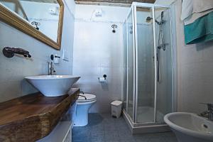 a bathroom with a shower and a sink and a toilet at Le Thovex in La Thuile