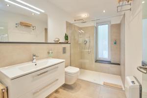 a bathroom with a sink and a toilet and a shower at Luxus Apartments Mosel-Zeit NEU 2023 in Zell an der Mosel