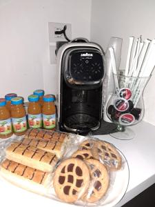 a counter with a plate of cookies and a toaster at Martina's House in Porto Cesareo