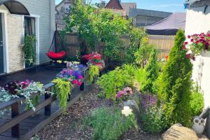 a garden with flowers and plants on a patio at Veski Villa in Pärnu