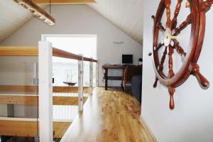 a room with a large clock on the wall and a staircase at Veski Villa in Pärnu