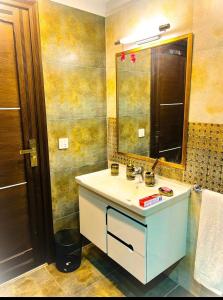 a bathroom with a sink and a mirror at LMY Residency - Bahria Town Lahore in Lahore +26 photos