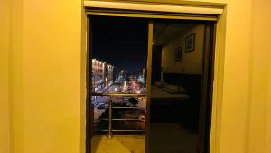 a view of a city street at night from a window at LMY Residency - Bahria Town Lahore in Lahore