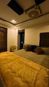 a hotel room with two beds and a window at LMY Residency - Bahria Town Lahore in Lahore
