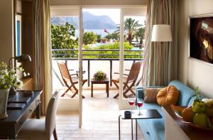a living room with a view of a balcony at Marti Resort Deluxe Hotel in Marmaris