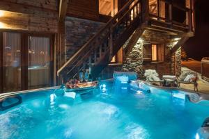 a large swimming pool in the middle of a house at Chalet Opale in Tignes