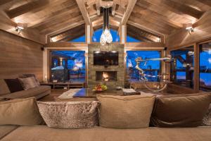 a living room with a couch and a fireplace at Chalet Opale in Tignes