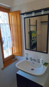 a bathroom with a sink and a mirror at Il Covo delle Regine in Abetone