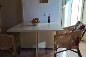 a table with a bowl of bread and a bottle of soda at Il Covo delle Regine in Abetone