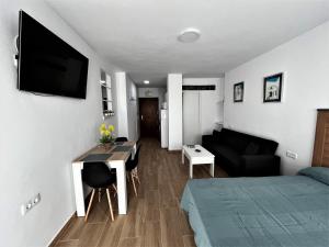 mały salon z łóżkiem i kanapą w obiekcie VER7 - ESTUDIO, Wifi, Fire Stick Amazon, Terraza, Vistas al mar, Piscina w mieście Torremolinos