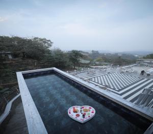 a heart shaped bowl sitting on top of a swimming pool at 360 South, Khandala in Lonavala