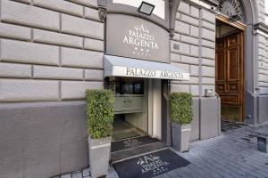 a shop with a sign on the front of a building at Hotel Palazzo Argenta in Naples