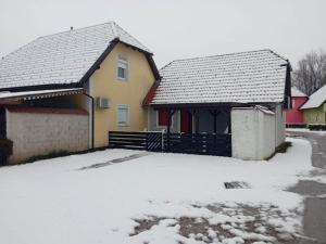 a house with snow in front of it at Apartmán Perspekta 196 in Čatež ob Savi
