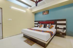 a bedroom with a bed in a room at FabExpress Apollo - Nr Odhav Ring Road in Naroda