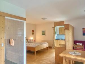 a small room with a bed and a bathroom at Landhaus Bender Ferienwohnung mit Terrasse und Garten in Straden