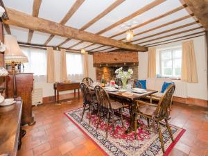 a dining room with a table and chairs at Pass the Keys Malt House With Hot Tub Stunning Tudor Cottage in Craven Arms
