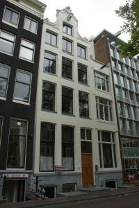 a large white building on the corner of a street at Grand Canal Boutique Hotel in Amsterdam