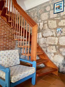 a wooden staircase with a blue chair next to it at Antica Peschiera Porto Botte in Porto Botte