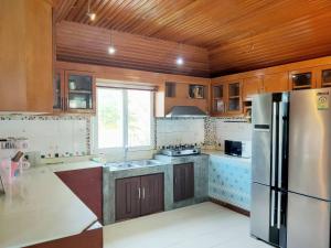 a kitchen with a stainless steel refrigerator and a window at The Park Pool Villa Pattaya in Pattaya Central