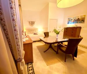 a living room with a table and a bedroom at The Maltese Sun in Sliema