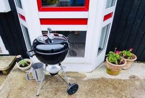 a bbq grill sitting in front of a door at Nice one-story house in Suduroy in Tvøroyri