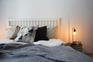 a bed with a blanket and pillows on it at L'Alberghetto in Trinità