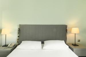 Postel nebo postele na pokoji v ubytování Le Palace Hotel