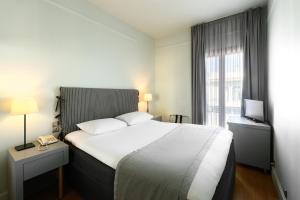 Postel nebo postele na pokoji v ubytování Le Palace Hotel