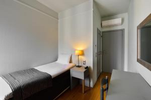 Ένα ή περισσότερα κρεβάτια σε δωμάτιο στο Le Palace Hotel