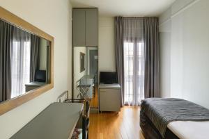 TV a/nebo společenská místnost v ubytování Le Palace Hotel