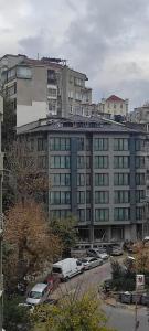 a large building with cars parked in a parking lot at Bolahenk Suites in Istanbul