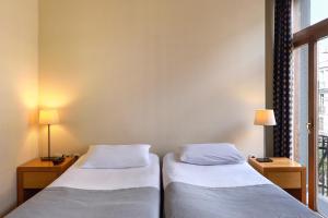 Postel nebo postele na pokoji v ubytování Le Palace Hotel