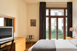 Postel nebo postele na pokoji v ubytování Le Palace Hotel