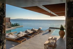 a villa with a pool and a view of the ocean at Lady Sea 6 Bedroom Villa with Heated Pool & Private Beach Access in Palaiokastro