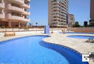 a swimming pool in front of a building at Apartamento Amatista 29A - Grupo Turis in Calpe
