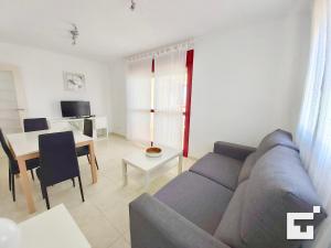 a living room with a couch and a table at Apartamento Amatista 29A - Grupo Turis in Calpe