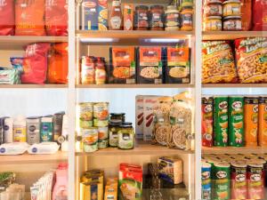 a refrigerator filled with lots of different types of food at Aparthotel Adagio access München City Olympiapark in Munich