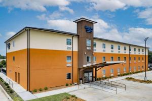 a rendering of a hotel with a building at Days Inn & Suites by Wyndham Horn Lake - Memphis Graceland in Horn Lake