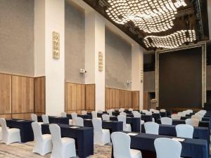 a room with rows of chairs and a stage at Sofitel Haikou in Haikou