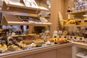 a display case in a store filled with fruits and vegetables at Aiden by Best Western Paris Roissy CDG in Roissy-en-France