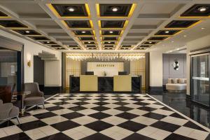 a lobby with a checkered floor and a reception at Ramada by Wyndham Erzurum in Erzurum